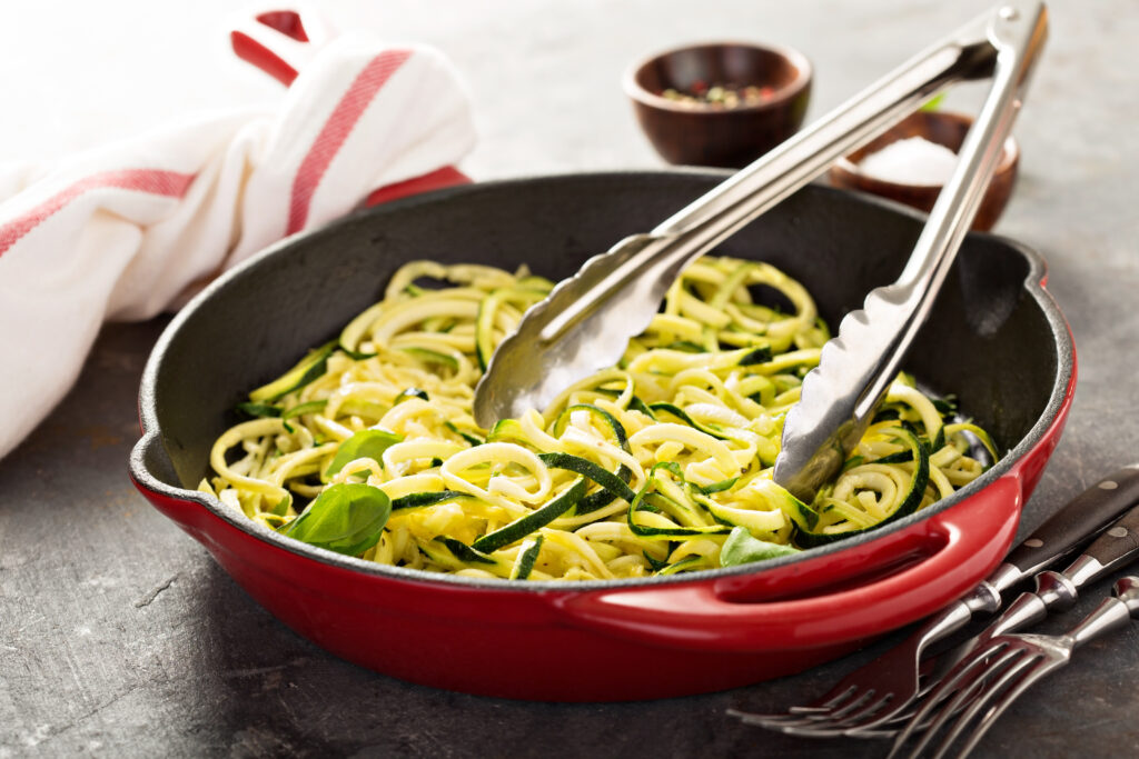 Sautéing Zucchini Noodles with Olive Oil and Pesto Sauce